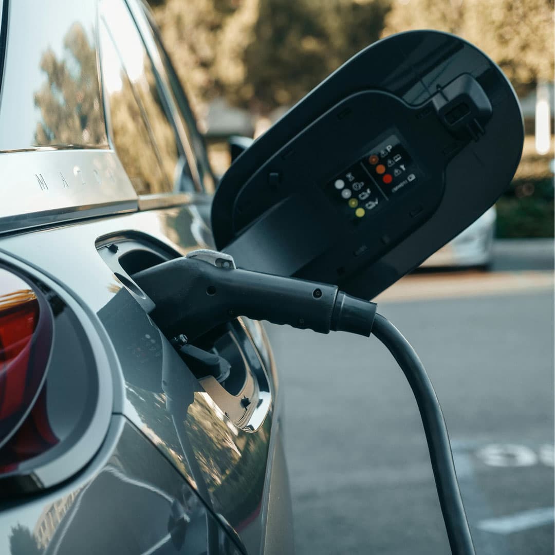 closeup-ev-charging-port-plugged1-1 closeup-ev-charging-port-plugged1-1