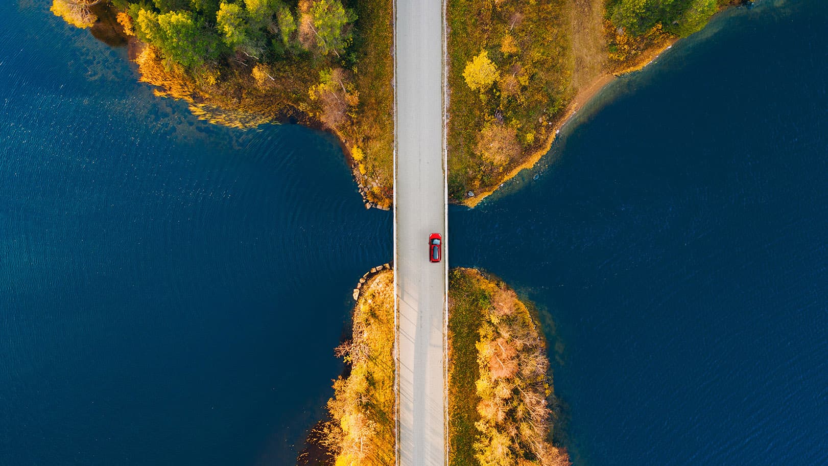 aerial-drone-view-of-fall-road-and-blue-water-lake-2025-03-18-15-31-41-utc-16-9 aerial-drone-view-of-fall-road-and-blue-water-lake-2025-03-18-15-31-41-utc-16-9