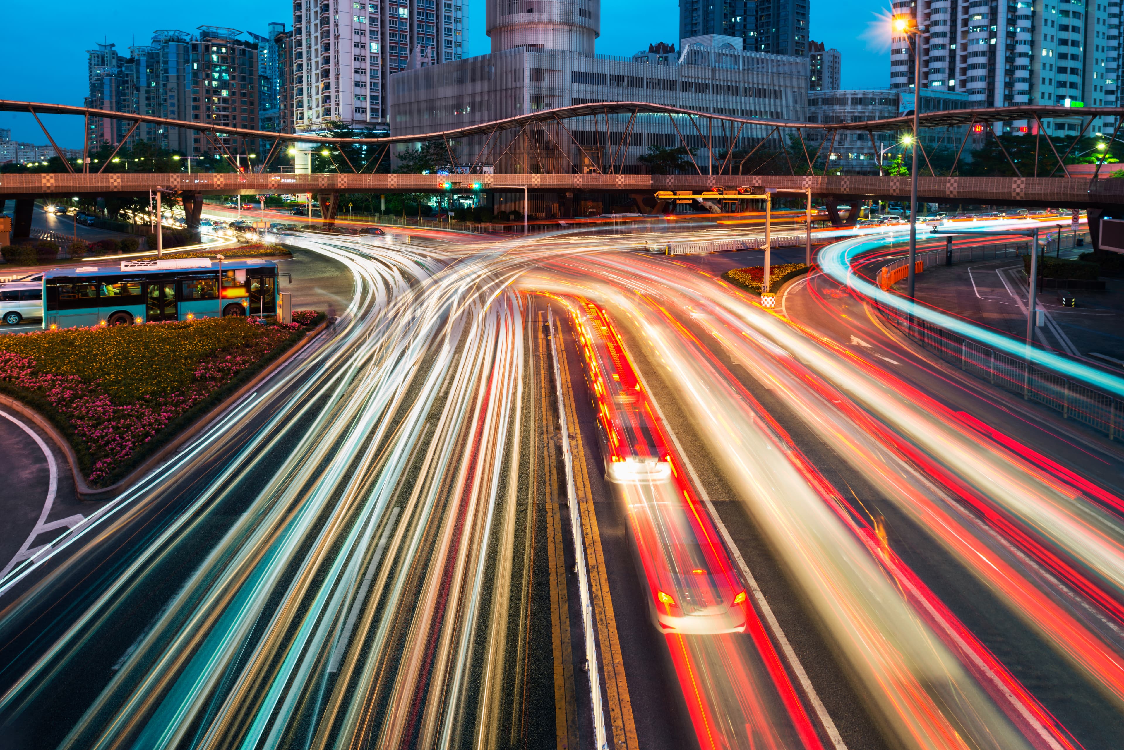 Long-exposure view of city traffic with light trails on a busy urban highway at night. Long-exposure view of city traffic with light trails on a busy urban highway at night.