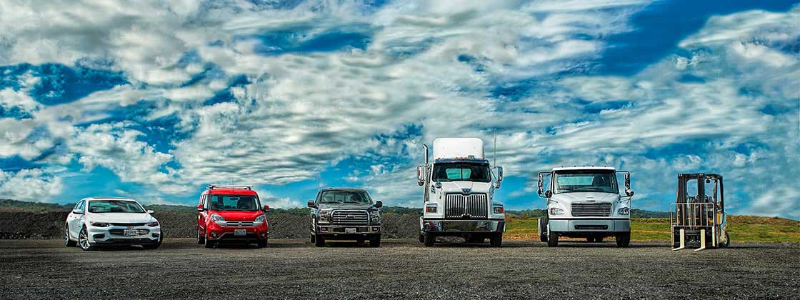 A row of commercial fleet vehicles ready to support business operations. A row of commercial fleet vehicles ready to support business operations.