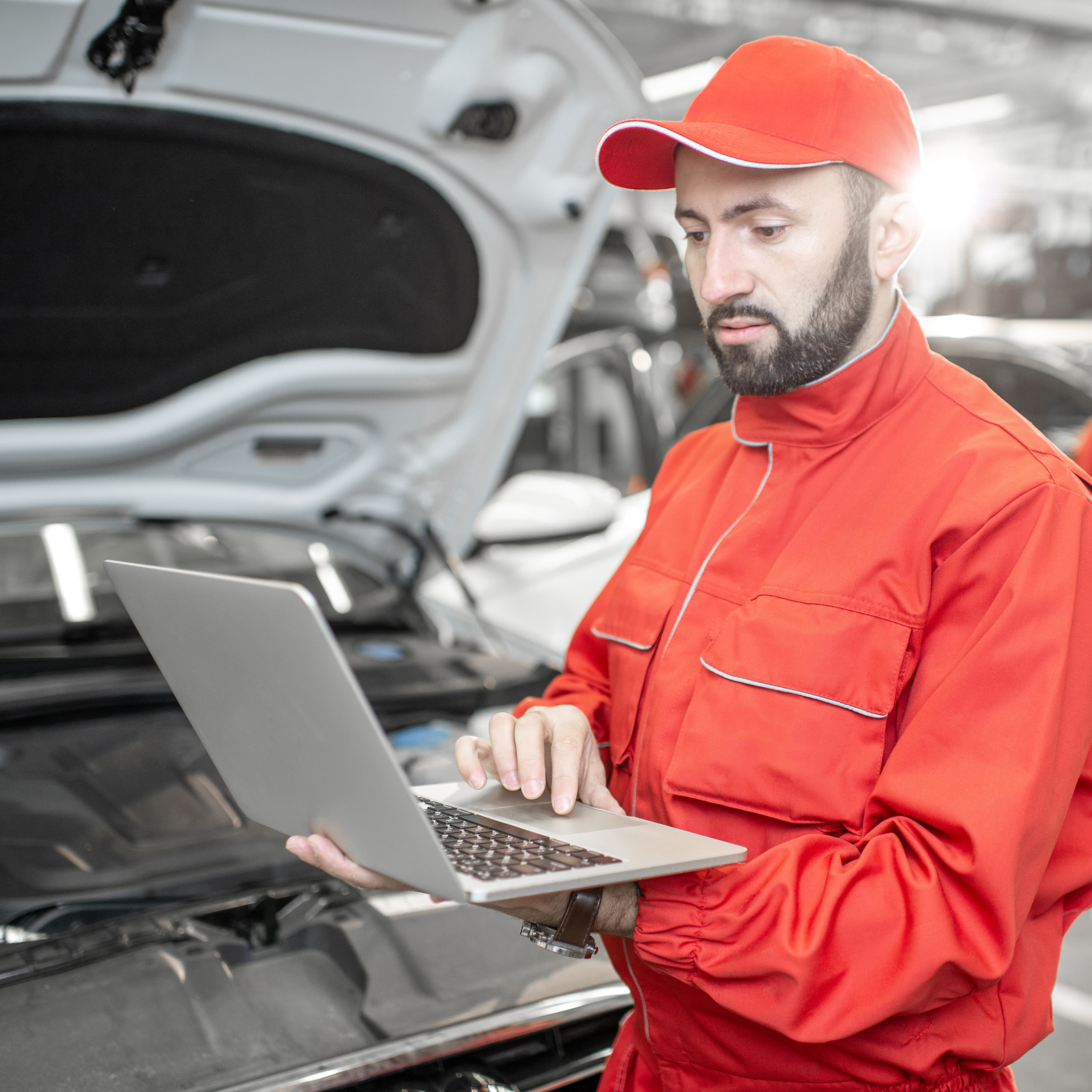 Auto mechanics doing diagnostics with laptop Auto mechanics doing diagnostics with laptop