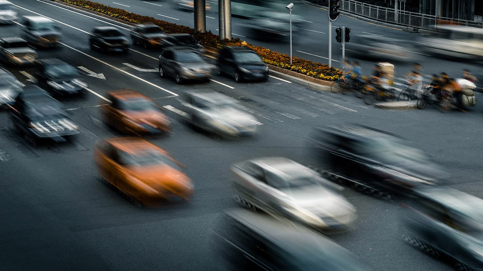 Vehicles traveling through a busy urban roadway, representing commercial fleet operations and mobility. Vehicles traveling through a busy urban roadway, representing commercial fleet operations and mobility.