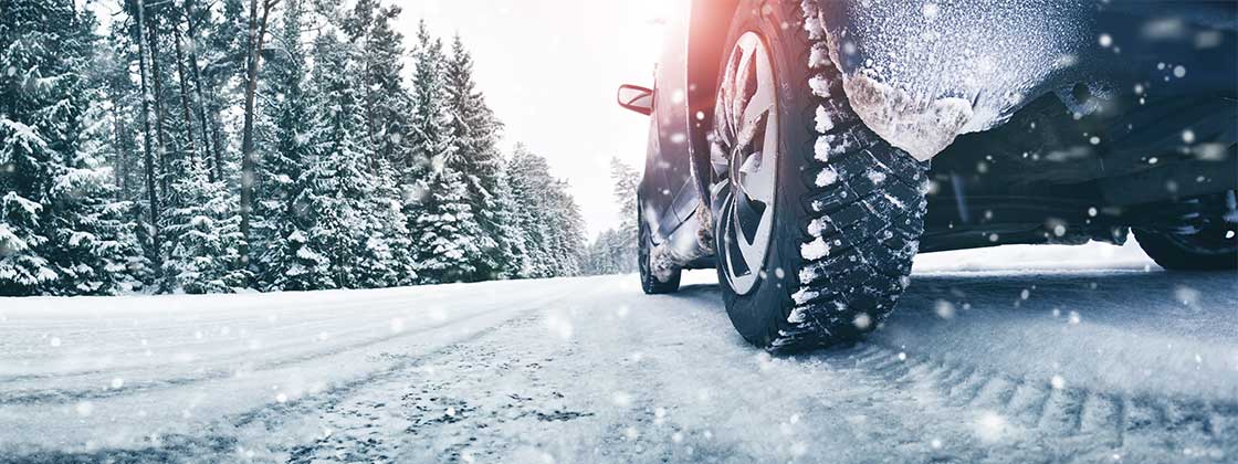 close up of tire driving in snow