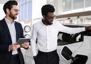 Fleet operators discussing electric vehicle options for cost-effective fleet vehicle acquisition