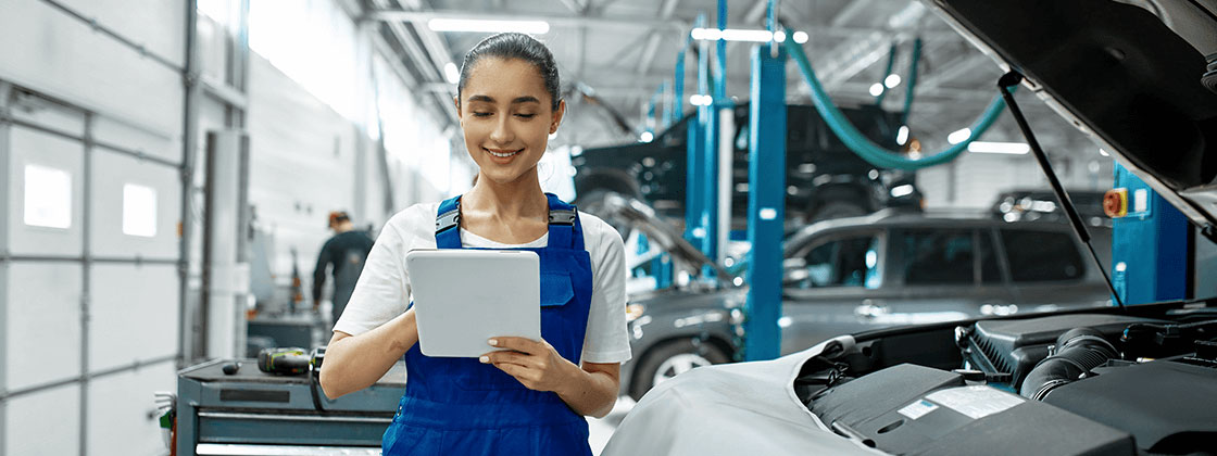 Woman working in automotive garage