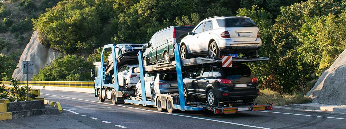 Truck with vehicles on trailer