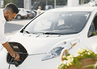 Fleet manager charging an electric vehicle as part of a sustainable fleet management strategy