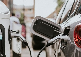 Electric vehicle charging at a public station with connected cables, showcasing sustainable fleet solutions