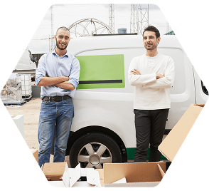 Two men standing by a work van