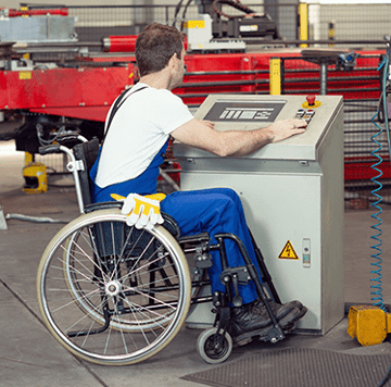 Mechanic in wheelchair working at repair shop