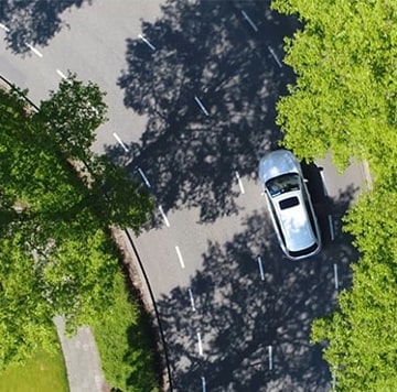 Overhead shot of road with white vehicle