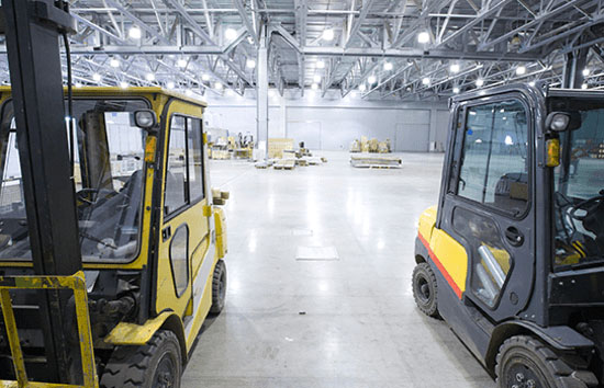 two fork lifts in warehouse